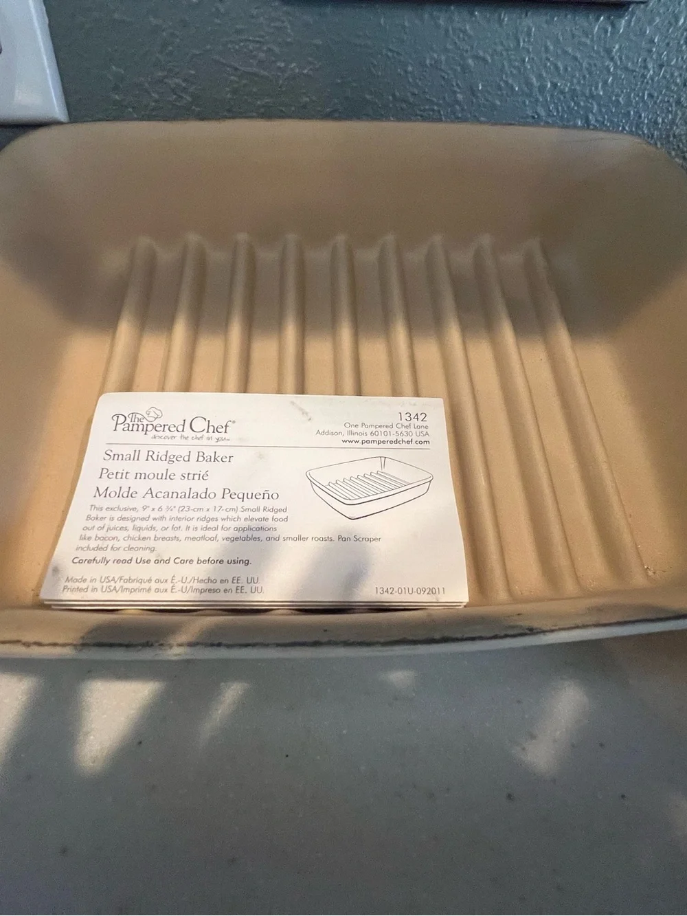 Pampered Chef Small Ridged Baker in tan-beige—never used.  New without box.